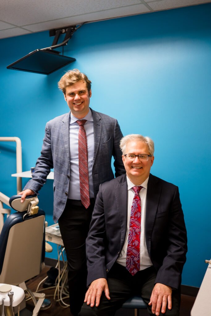 Dr. Gregory Lane, a Dentist in Carol Stream, standing in the dental practice's office, smiling at the camera
